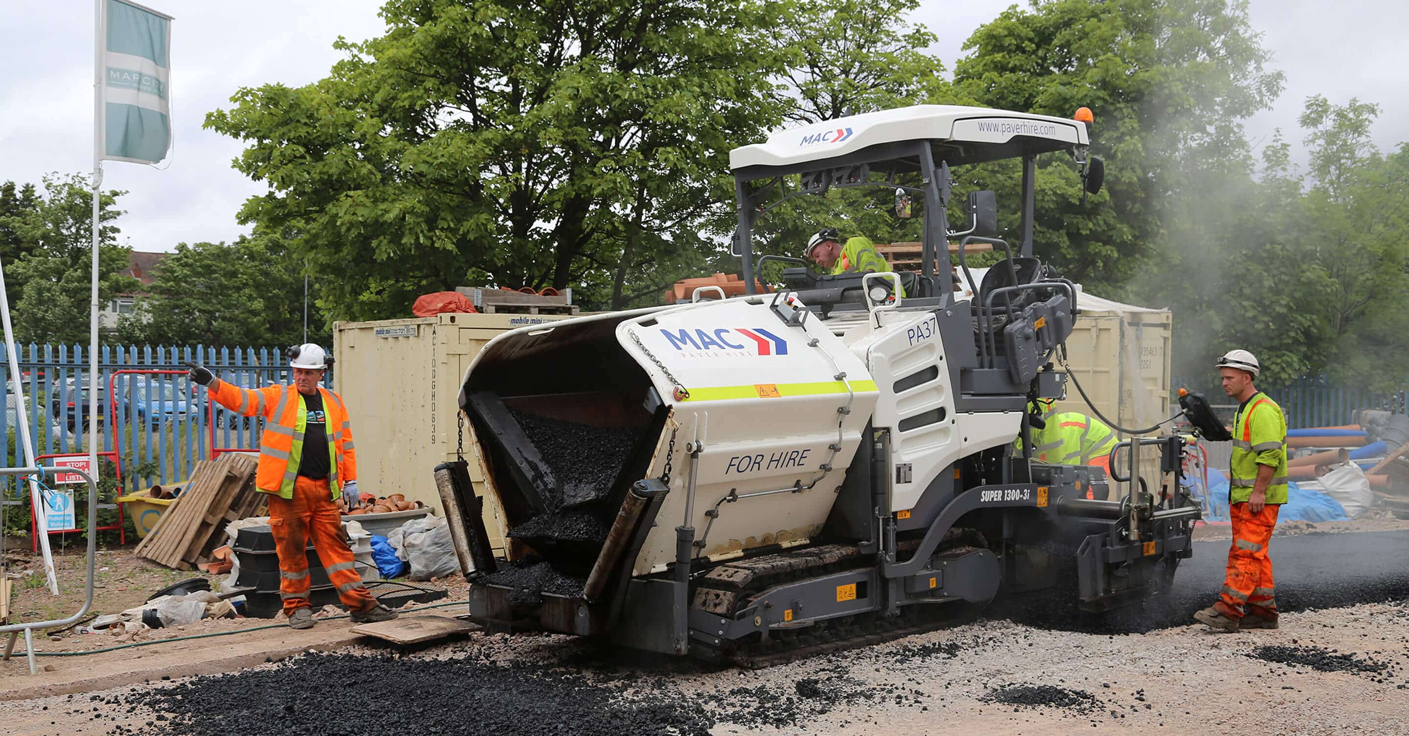MAC Surfacing paver and paving crew laying asphalt